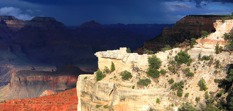 Exploring the Grand Canyon from the South Rim in Arizona with rocky formations and shadows across the landscape