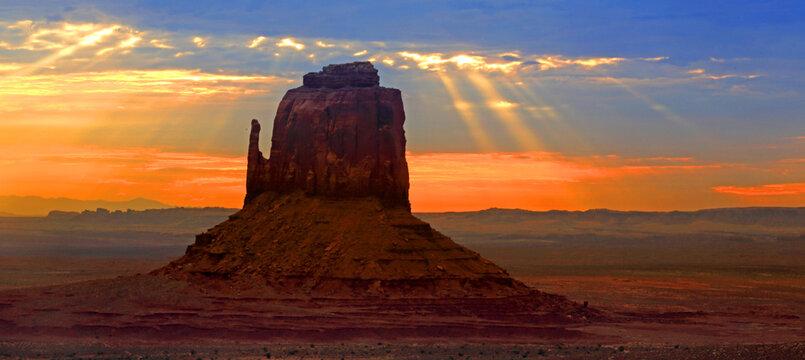 Sunrise over the butte in Monument Valley, highlighting the natural landscape of the Navajo Indian Territory in Utah