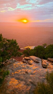 Bright sunset seen over the canyon landscape from Grand View Point in Canyonlands National Park, Utah, USA