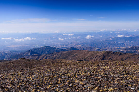 Panoramic view from the upper slopes of Sierra Nevada National Park with clear skies over the plateau in southern Spain