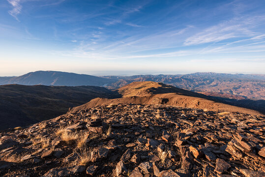 Wide summit ridge offers panoramic mountain views from Pico del Caballo in Sierra Nevada in Andalusia, Spain, near the city of Granada