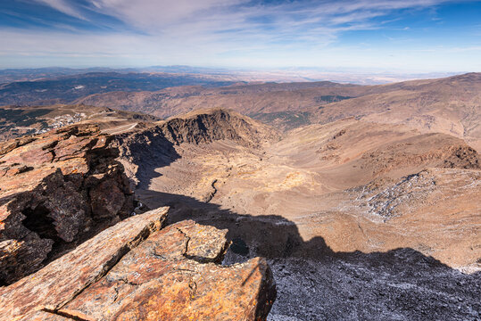 Sky view from Pico de la Veleta with jagged rocks and barren ridges in Sierra Nevada of Andalusia