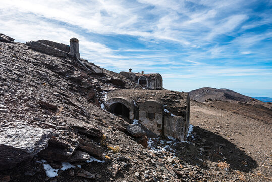Ruins of a stone refuge and civil war shelter stand among rocky terrain in the Sierra Nevada mountains of Andalusia, Spain