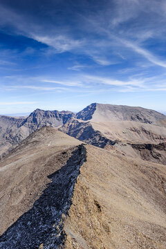 View from summit of Pico de la Veleta showcasing ridges leading to Mulhacen and Alcazaba in Sierra Nevada, Spain