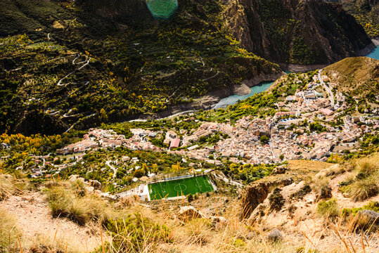 View of Guejar Sierra village near the blue waters of Guejar Embalse lake in Spain&acirc;&euro;&trade;s Sierra Nevada region