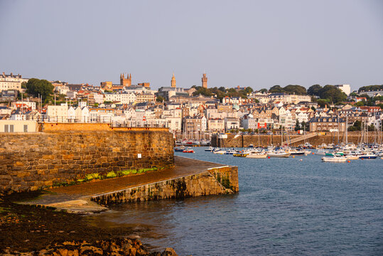 Views of waterfront and historic buildings during golden hour in Saint Peter Port in Guernsey Channel Islands