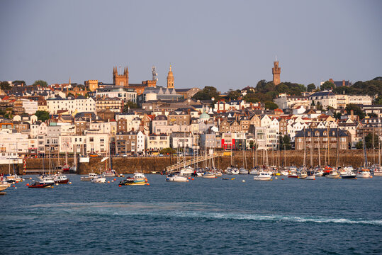 Skyline view of Saint Peter Port showing churches and buildings along the waterfront in Guernsey Channel Islands