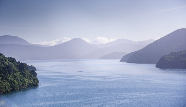 Dawn breaks over misty bays and mountains in Marlborough Sounds, South Island, New Zealand