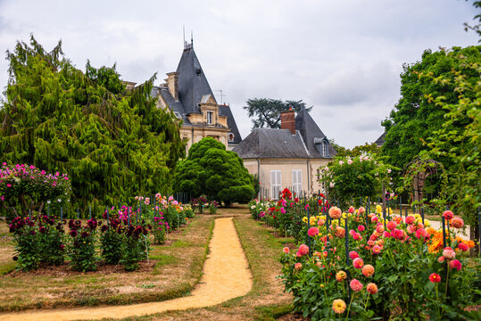 Explore blooming flowers and paths leading to a pavilion in Thabor Gardens in Rennes, Brittany, France