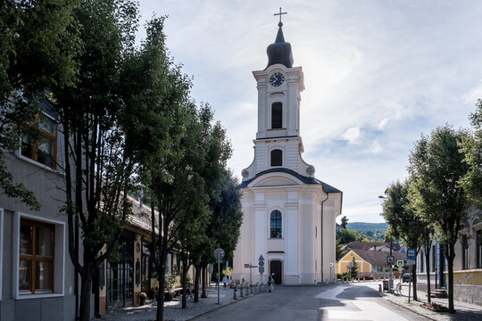 View of Church of St. John the Baptist and city center in Visegrad with green hills in the background