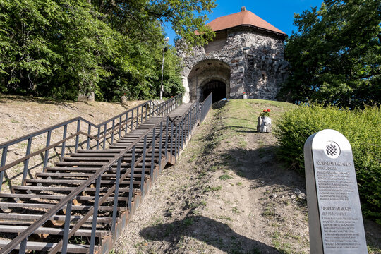 View of the entrance to Visegrad Castle at Danube Bend accessed by a metal stairway and forest path