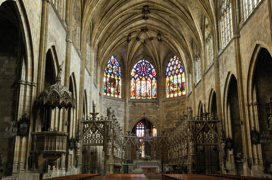 Interior view of Saint-Pierre Cathedral showing arches and stained glass windows in Condom, Gers department, Occitanie region, France