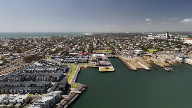 Port Adelaide, South Australia: 4K aerial drone footage of harbour, Port River, marina, coastal suburbs and historic waterfront cityscape, presidential houses, estates in Semaphore, Birkenhead. 