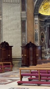 St Peters Basilica confessionals stand as intimate booths pilgrims quietly confess pray reflect while visitors admire ornate artworks sacred marble interiors. Vatican City, Italy 11.30.2025