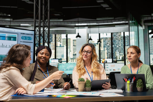 Diverse group of business partners analyzing project agenda fueled by collaboration and determination, aligning corporate goals to build a unified vision. Team networking concept.