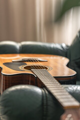 Fototapeta premium Acoustic guitar resting in cozy interior with natural light. Minimal music background.