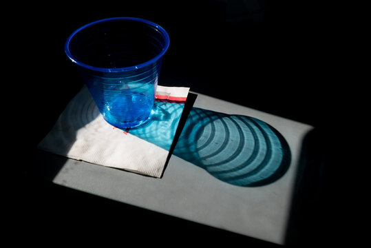 An empty plastic glass on an airplane tray.
