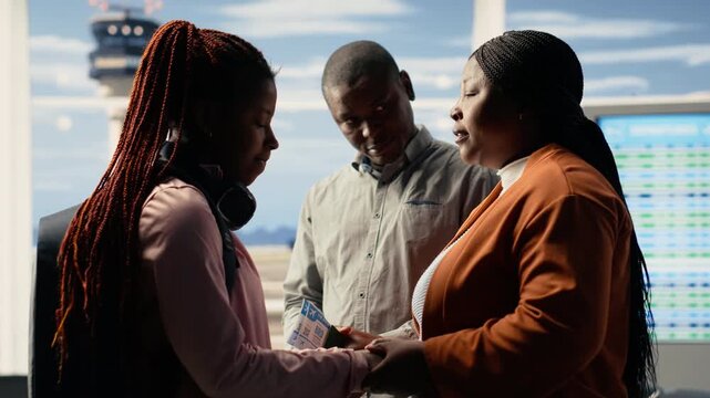 Supportive parents and teenage child in sad goodbye at the airport terminal, the pain and pride of sending young solo traveler to study abroad. International student life, departure time.