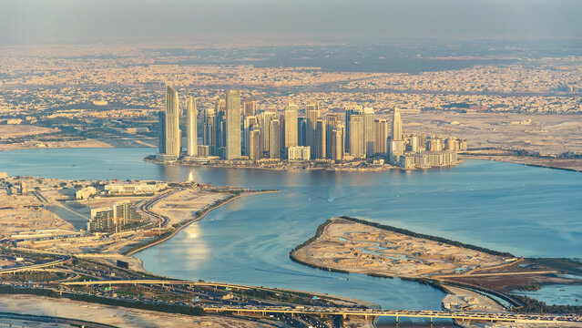 Aerial view of Dubai Creek Harbour skyscrapers at sunset