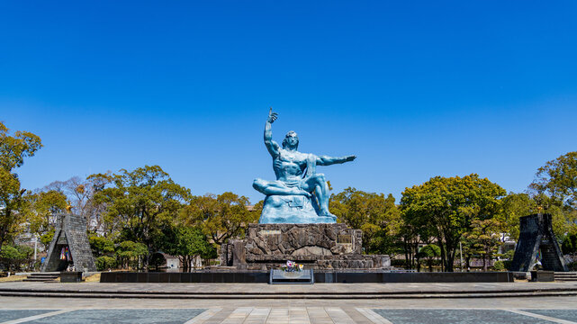 Peace Statue in Nagasaki Peace Park under a clear blue sky