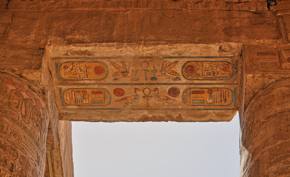 Colorful painted hieroglyphs on ancient stone lintel at Karnak Temple in Luxor Egypt