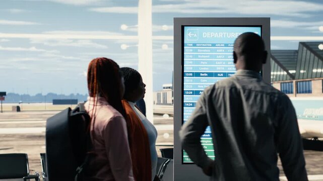 Stranded people reacting to bad news of cancelled flights and suspended departures, chaotic airport scene. Diverse crowd looking at the schedule board in disbelief, ruined travel plans.