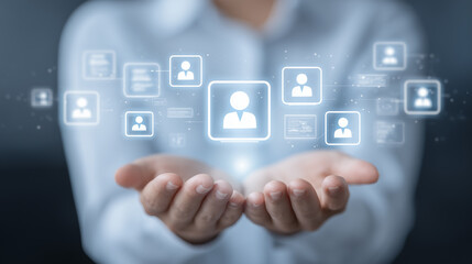 Naklejka premium Hands presenting digital user icons in a virtual interface representing customer identity, human resources, and connected people management. 