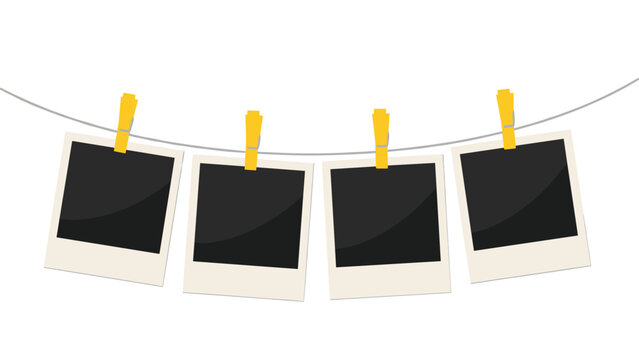 Four blank instant photo frames hang from a thin wire with yellow clothespins against a clean white background.