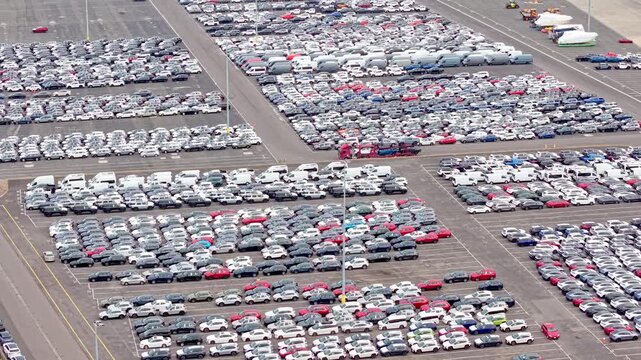 Large-scale car storage lot with rows of vehicles