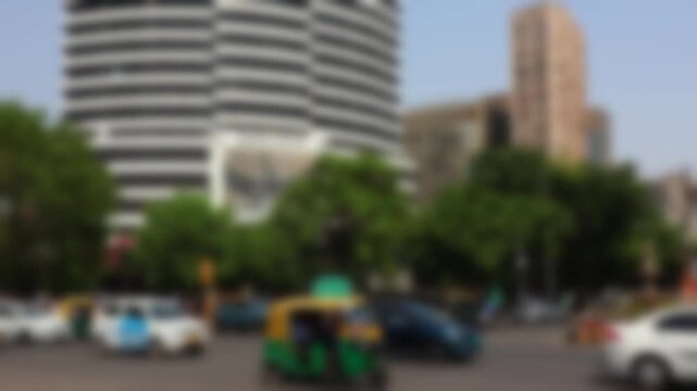 Blurry road traffic on a sunny day in downtown of New Delhi, India. Bokeh real time motion video for background.	