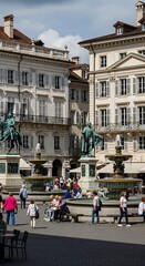 Obraz premium Picturesque Lucerne Square - A vibrant scene of people and architecture.