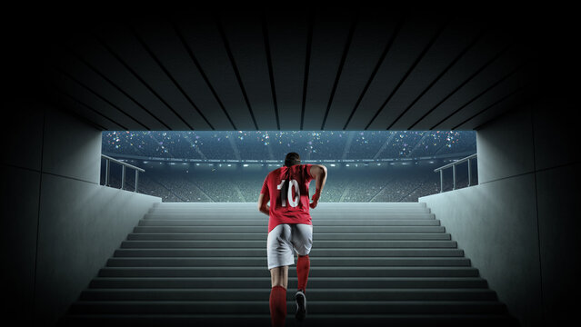 Back view of soccer player entering soccer field from tunnel. An imaginary soccer stadium is modelled and rendered.