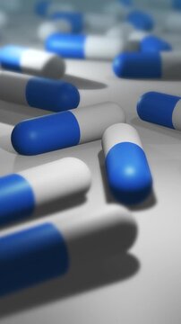Camera Pans Across Cinematic Blue and White Pill or Drug Capsules - Vertical