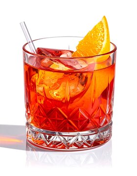A short cocktail glass filled with a reddish drink and ice
