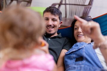 Obraz premium Happy parents enjoying quality time together with their child while relaxing outdoors