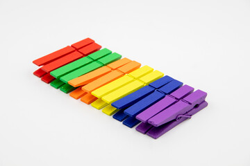 Fototapeta premium colorful household wooden сlothes pins isolated on white background.