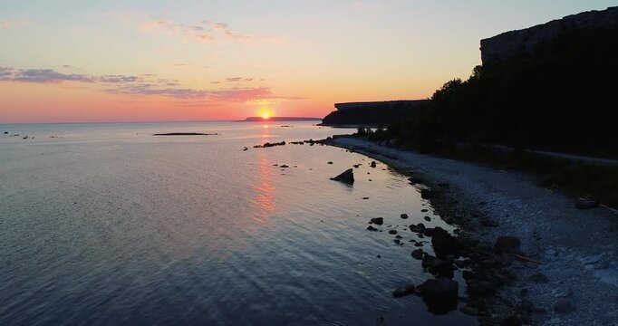 Aerial sunrise over Baltic Sea with Lilla Karls&ouml; seen from Stora Karls&ouml; coastline, Gotland Sweden