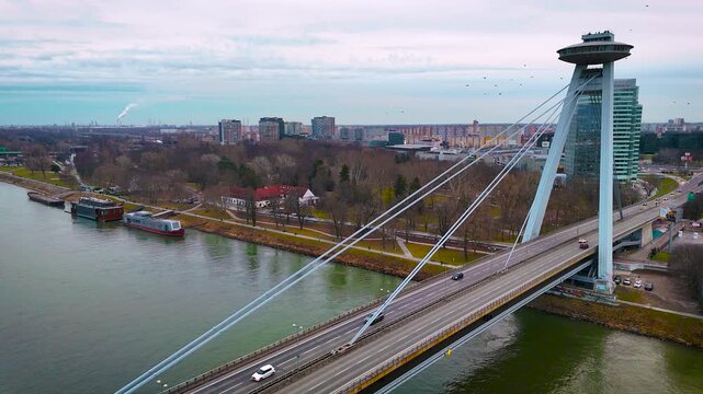Close view of the UFO Bridge observation deck in Bratislava above the Danube at blue hour with sweeping city panorama; ideal for travel, architecture, tourism and editorial use