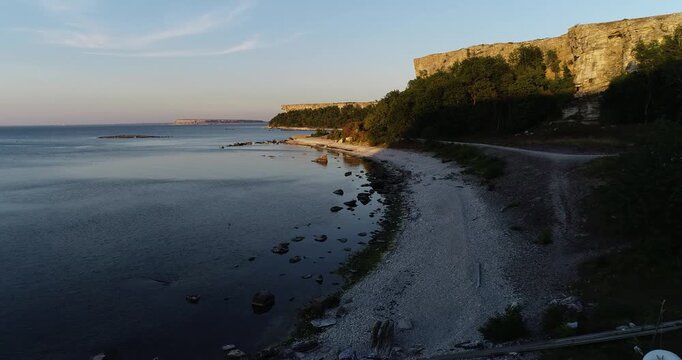 Aerial coastline of Stora Karls&ouml; with cliffs and Baltic Sea in evening light, Gotland Sweden Part 1
