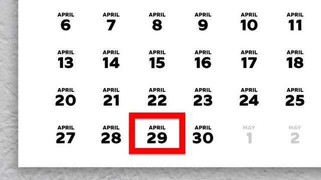 The date April 29th marked with a red cursor on the wall calendar 2026