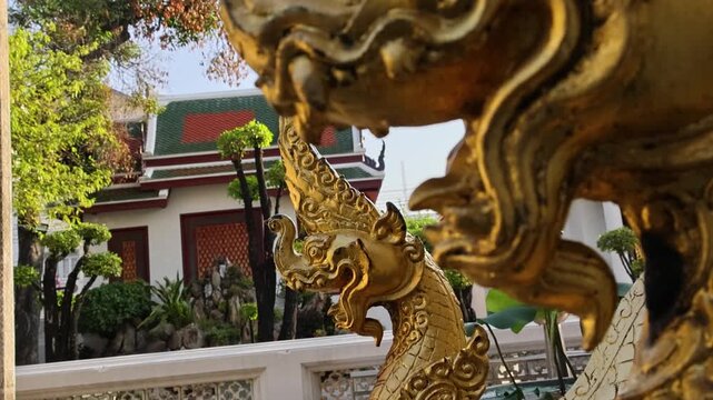 Golden Naga serpent statue Thai temple ornate architecture exterior