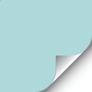 Paper folded corners of light blue and white paper on a gray surface