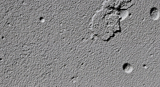 Rough gray lunar surface texture with deep craters and terrain.