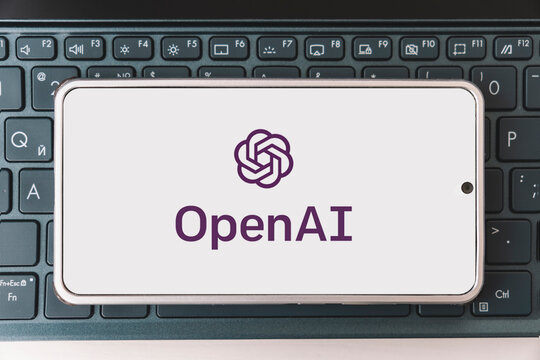OpenAI logo seen on screen smartphone and laptop. Open AI - American company engaged in the development and licensing of machine learning-based technologies.