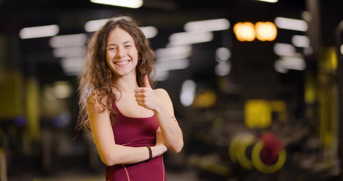 Fitness friends gather at the center for group exercise fun with a lady showing enthusiasm and joy throughout the workout session