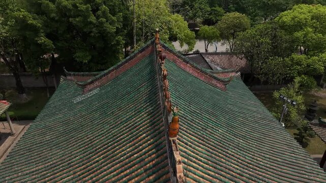 Aerial view of a historic chinese temple roof with dragon statues