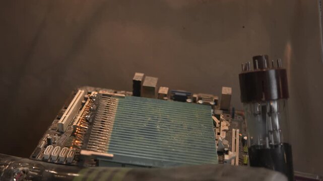 Close Up Of Aged Electronic Circuitry Being Examined With Repair Tools And Warm Illumination . Media