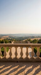Naklejka premium Stone balustrade overlooking rolling countryside at sunset
