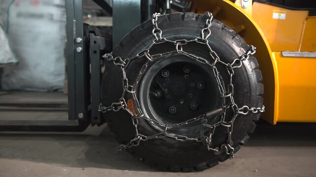 Forklift Safety Inspection. Warehouse Vehicle Maintenance With Focus On Wheel Bolts And Tread Condition . Media
