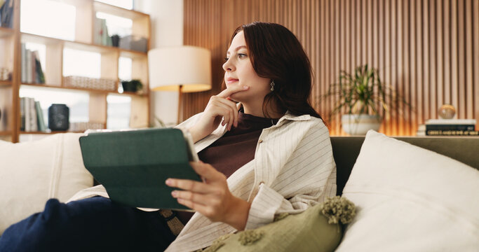 Relax, tablet and thinking with woman on sofa in living room to search review of streaming service. App, planning and subscription with person browsing internet for media choice, decision or options